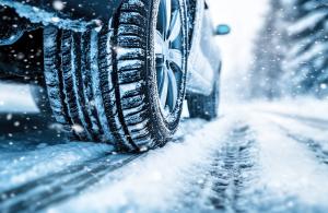 Car in the winter driving on snowy road